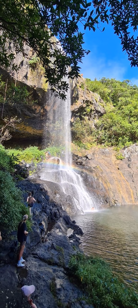 People admiring the beautiful waterfall
